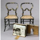 A pair of mother-of-pearl inlaid and gold painted ebonised occasional chairs with open kidney-shaped
