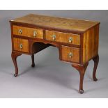 A walnut knee-hole desk fitted with an arrangement of four drawers, & on short cabriole legs & pad