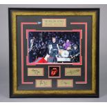 A framed display “The Rolling Stones” with photographs & autographs, lacking certificate, 19” x