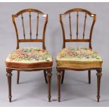 A pair of 19th century inlaid-beech spindle-back occasional chairs with padded seats, and on