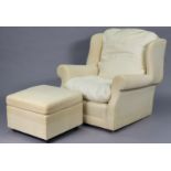 A wing-back armchair upholstered cream material; & a similar square footstool.