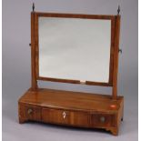 A 19th century mahogany rectangular swing toilet glass fitted three small drawers to the bow-front