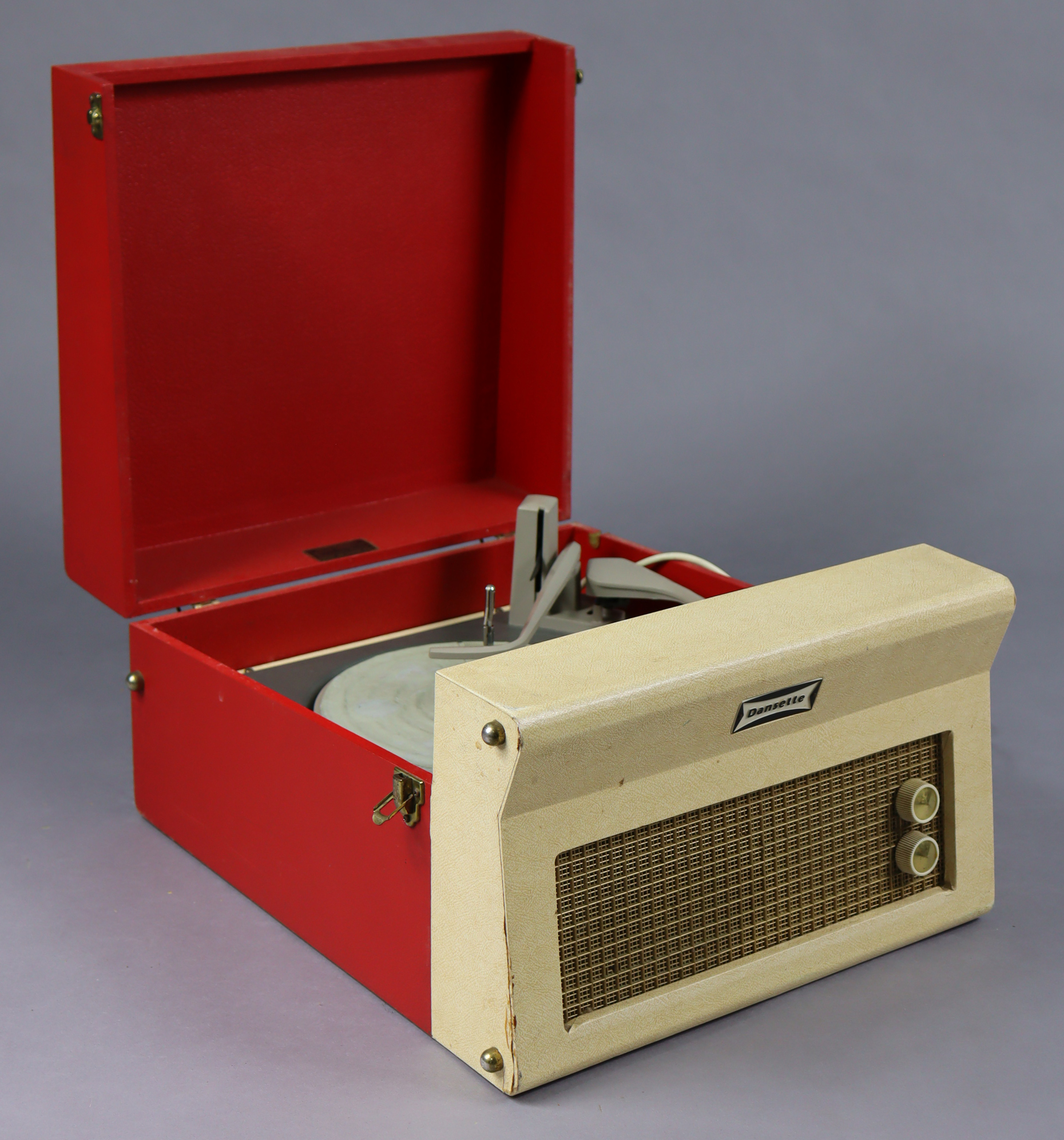 A vintage Dansette portable record player in red & cream fibre-covered case.