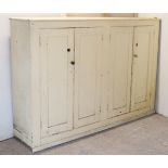 An early 20th century cream painted pine large side cabinet fitted three shelves enclosed by two