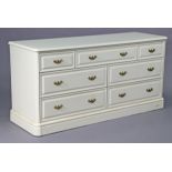 A ditto dwarf chest fitted with an arrangement of seven drawers, 56” long x 27½” high.