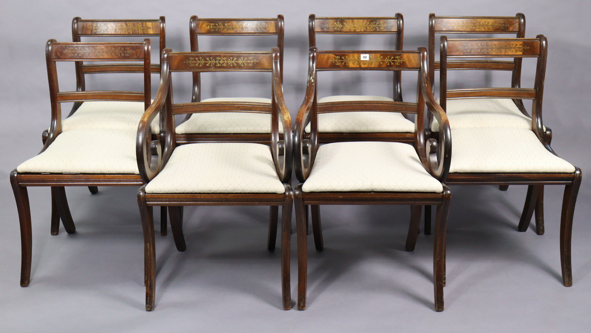 A set of eight regency-style brass-inlaid bow-back dining chairs (including a pair of carvers), with