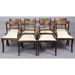 A set of eight regency-style brass-inlaid bow-back dining chairs (including a pair of carvers), with