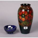 A Moorcroft pottery vase of ovoid form & with bright-coloured floral decoration, 10” high; & a ditto