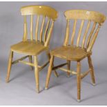 A pair of lath-back kitchen chairs with hard seats, and on ring-turned legs with turned stretchers.