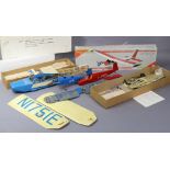 Four model aeroplane construction kits, part assembled, two unboxed.