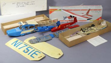 Four model aeroplane construction kits, part assembled, two unboxed.