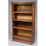 A Globe Wernicke oak four-tier sectional bookcase, on a plinth base, 34” wide x 61” high x 12” deep.