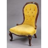 A Victorian carved beech frame nursing chair with a buttoned back & sprung seat upholstered gold