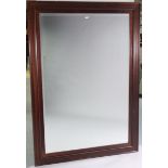 A large hardwood frame rectangular wall mirror inset with a bevelled plate, 67½” x 47½”.