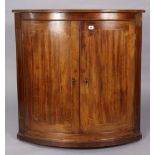 A 19th century inlaid-mahogany large bow-front hanging corner cupboard, fitted two shelves, 36” wide