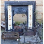 A cast-iron fire surround inset with a tile border, 38” wide x 39” high; & three iron fire baskets.