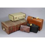 A fibre-covered travelling trunk, 36” wide; together with two suitcases; and two briefcases.