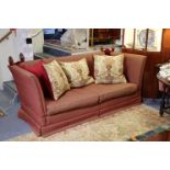 A Knowle-style three-seater drop-end settee upholstered crimson material 80” long.