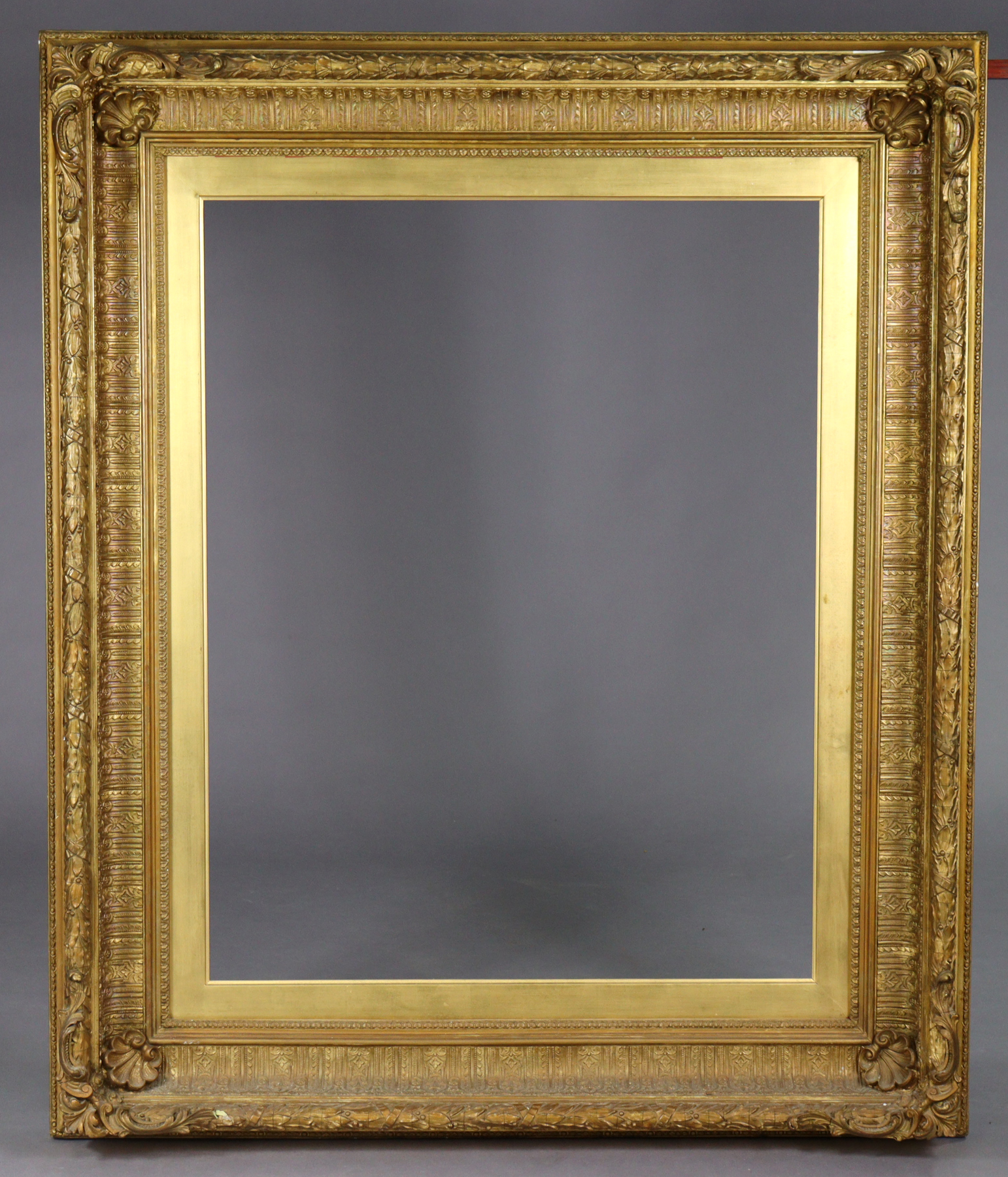 A large antique giltwood & gesso picture frame, 50” x 42” over-all.