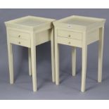 A pair of continental-style cream-finish wooden tray-top bedside tables each fitted two long