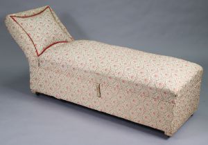 A mid-20th century daybed with a scroll end & hinged box seat upholstered multi-coloured geometric