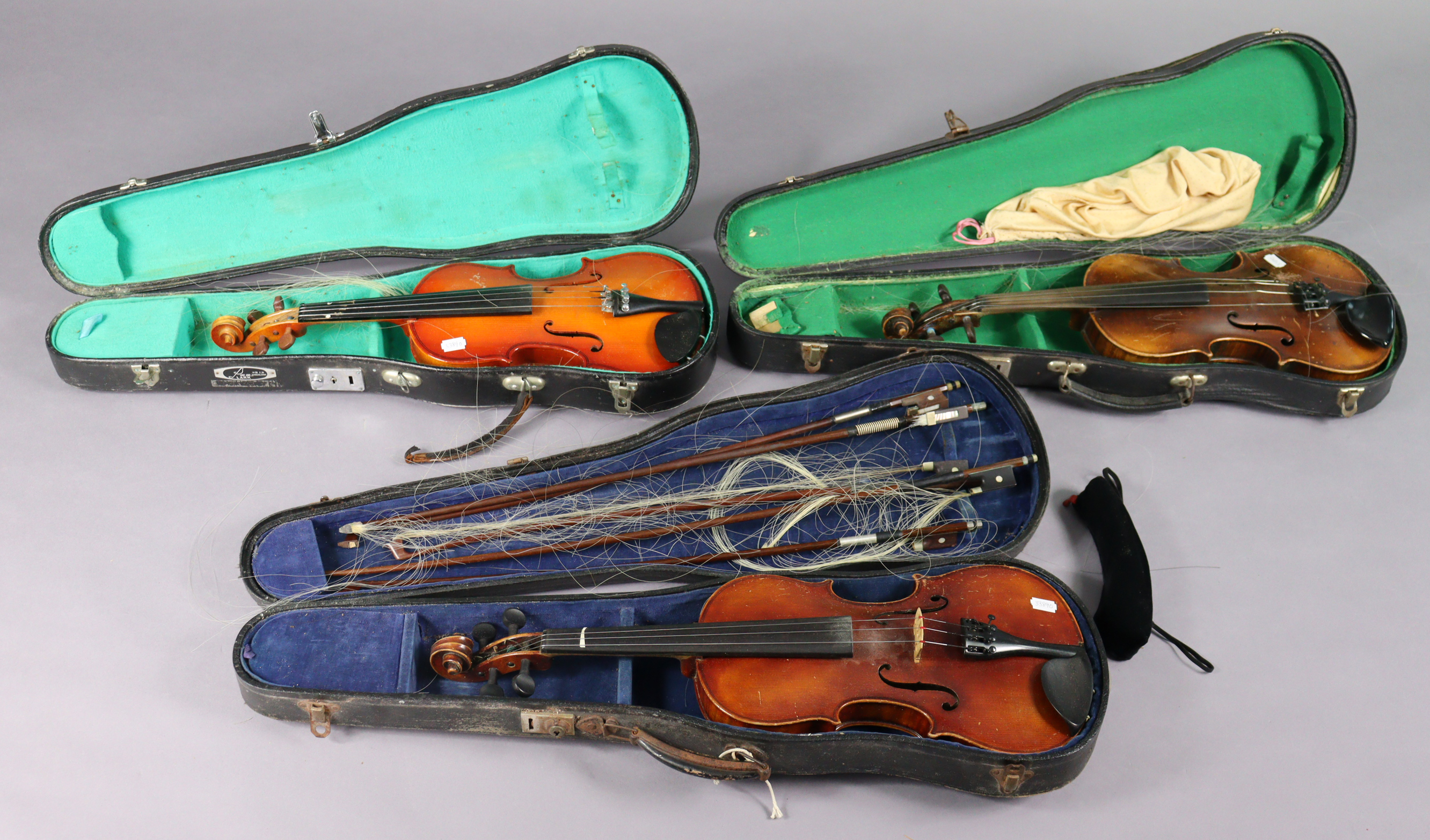 Three vintage violins & five bows, each with a case.
