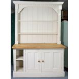 A continental-style natural and white painted pine dresser the upper part fitted two open