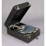 A Columbia portable gramophone in black fibre-covered case; & twenty-one various records.
