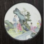 An early 20thC Chinese porcelain panel, decorated in famille rose with conversational figures,