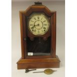 A late 19thC Seth Thomas walnut cased mantel clock with a stepped top, over a full height, glazed