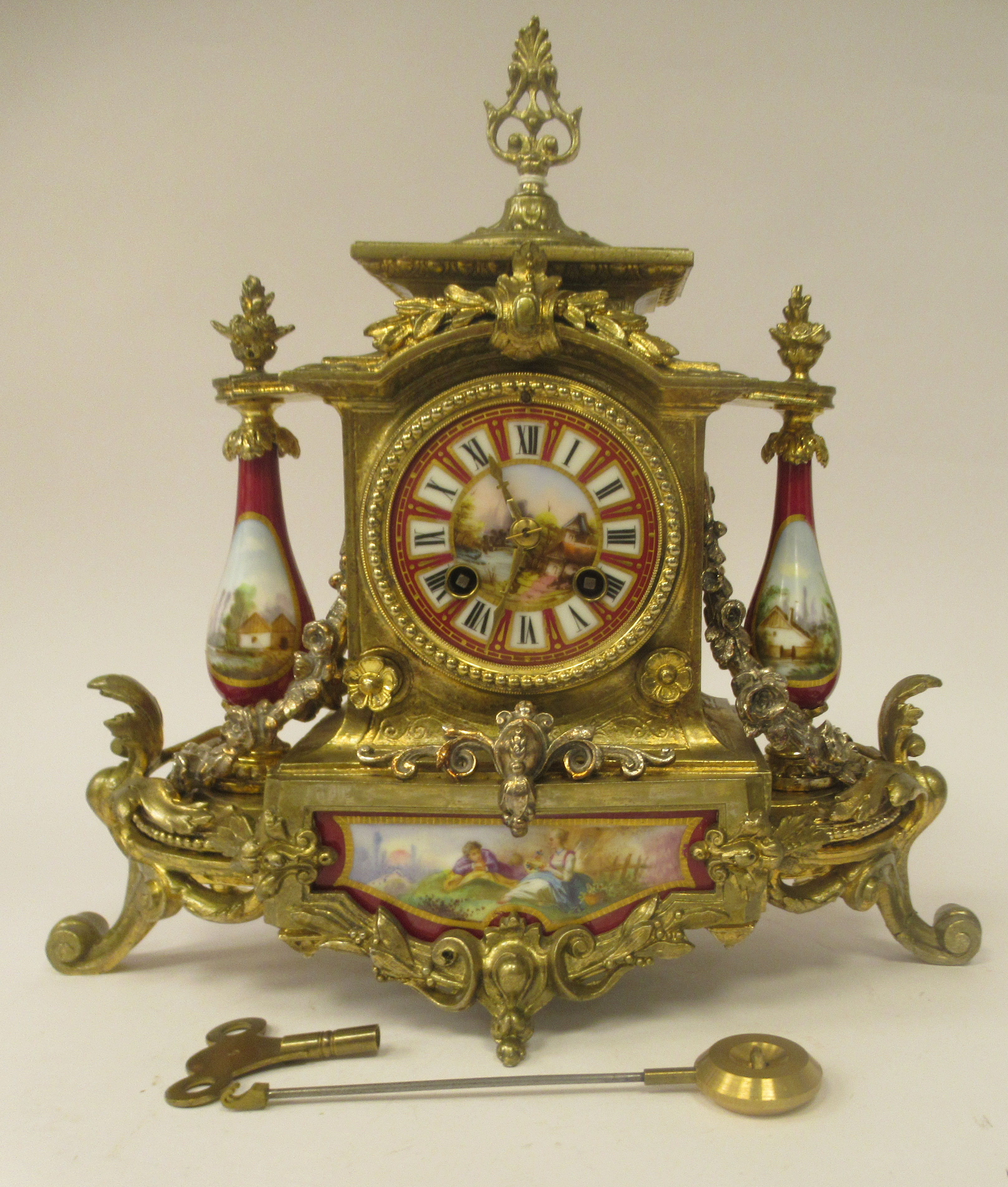 A late 19thC French Brunfaut gilt metal and painted porcelain cased mantel clock with pillared