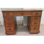 An Edwardian oak twin pedestal desk with an arrangement of nine drawers, on a plinth  30"h  44"w