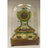 A late 19thC French mantel clock, in a two part waisted gilded, floral patterned apple green and