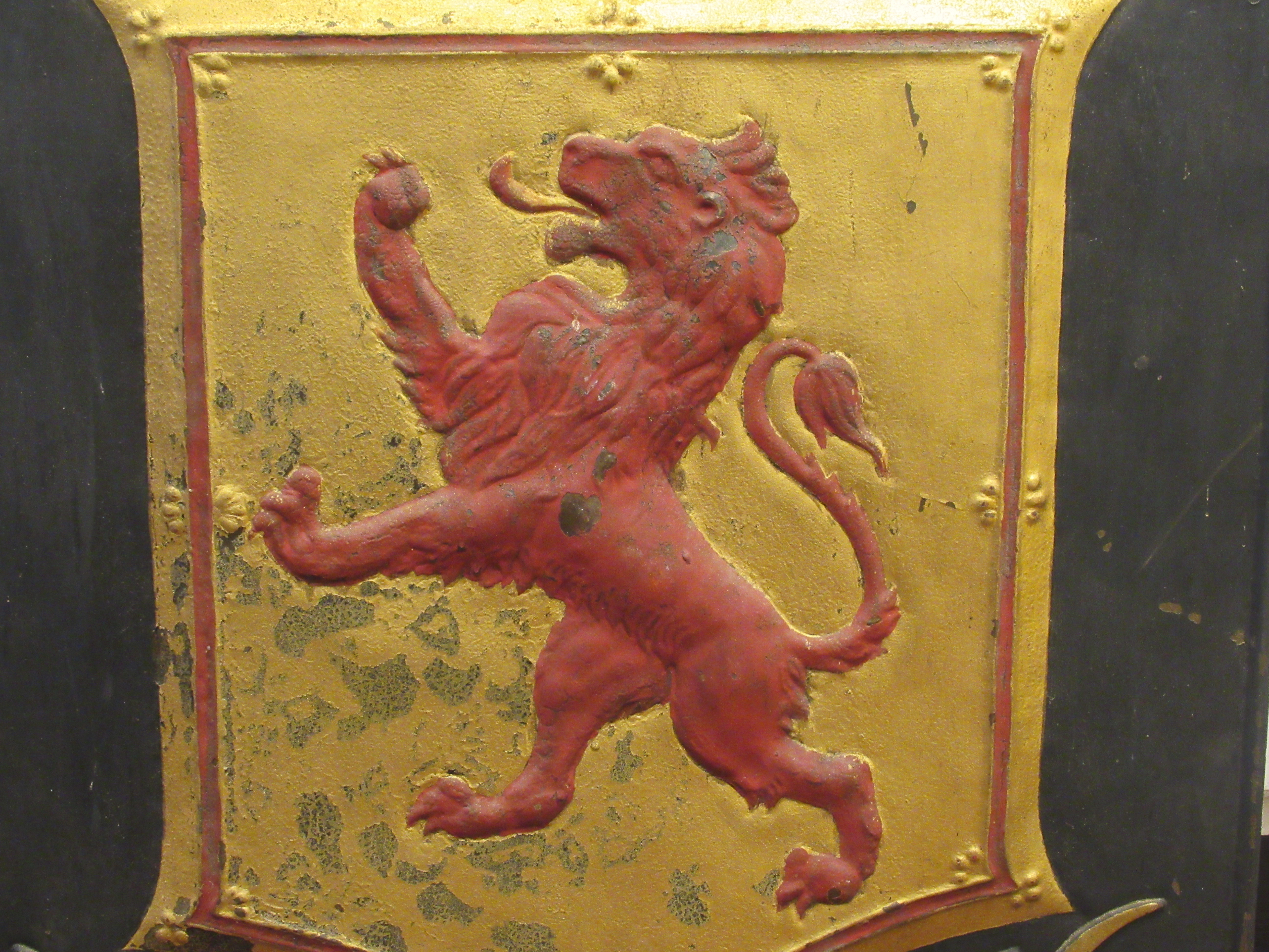 A 19thC black, red and gilt painted cast iron external hanging  advertising sign, featuring a lion - Image 2 of 3