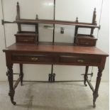 An Edwardian mahogany dresser with an arrangement of open shelves and drawers, over two frieze