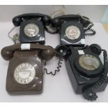 Four similar 1960s/1970s telephone handsets, three black and one chocolate brown plastic with cradle