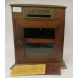 An early 20thC mahogany desktop post box with a domed top, straight sides and a lockable hinged