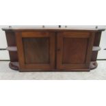 A mid Victorian mahogany breakfront hanging cabinet with a pair of central doors, flanked by two