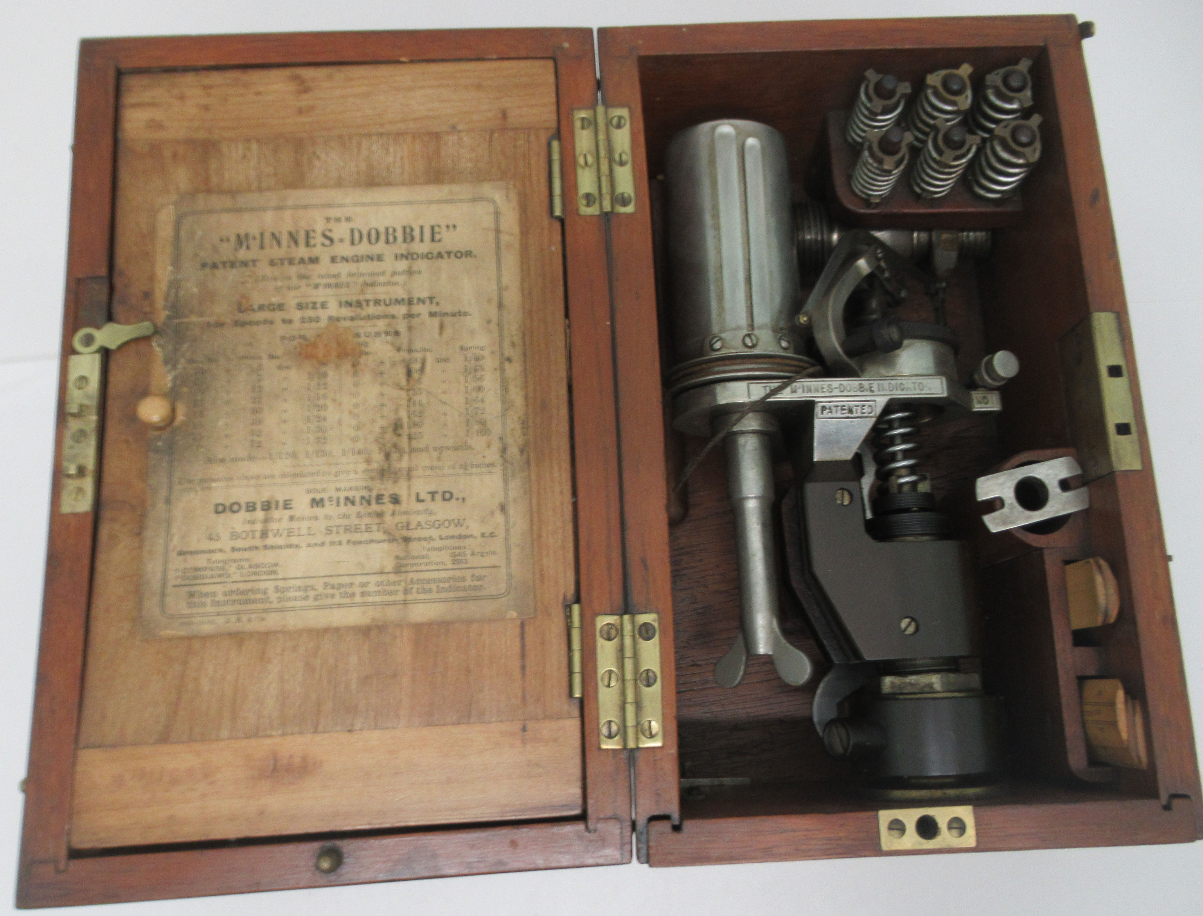 The McInnes-Dobbie patent steam engine indicator, in a mahogany carrying case