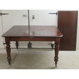 A late Victorian mahogany dining table, the two part top with a thumb moulded edge and rounded