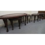 A set of five 20thC Indonisian hardwood occasional tables with foliate carved ornament, raised on