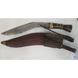 An Indian kukri with a part brass bound handle, the blade 13.5"L in a hide covered sheath