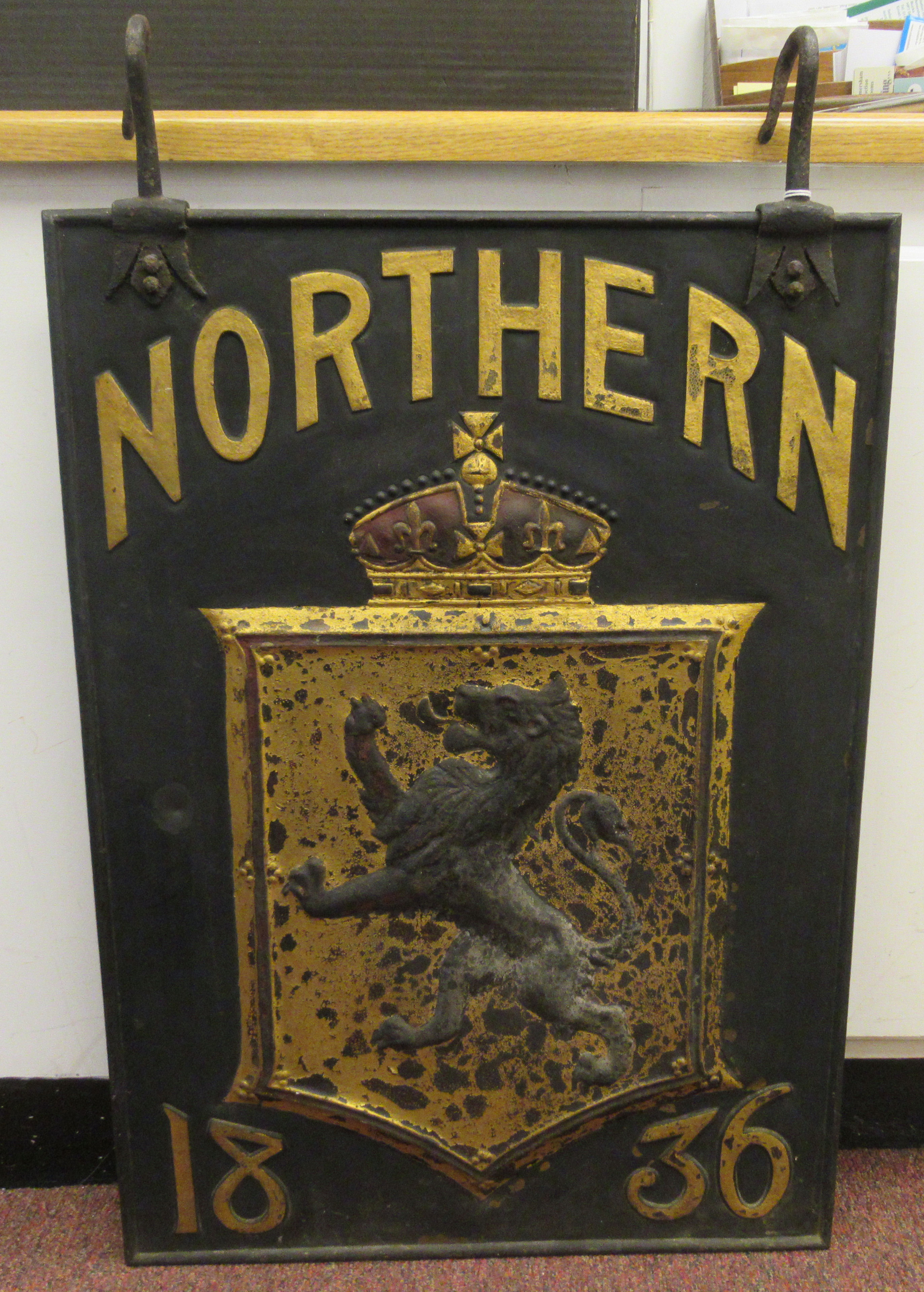 A 19thC black, red and gilt painted cast iron external hanging  advertising sign, featuring a lion - Image 3 of 3