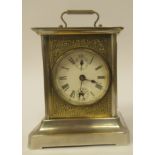 An early 20thC electroplated and brass inlaid mantel clock with a glazed panel and a folding top