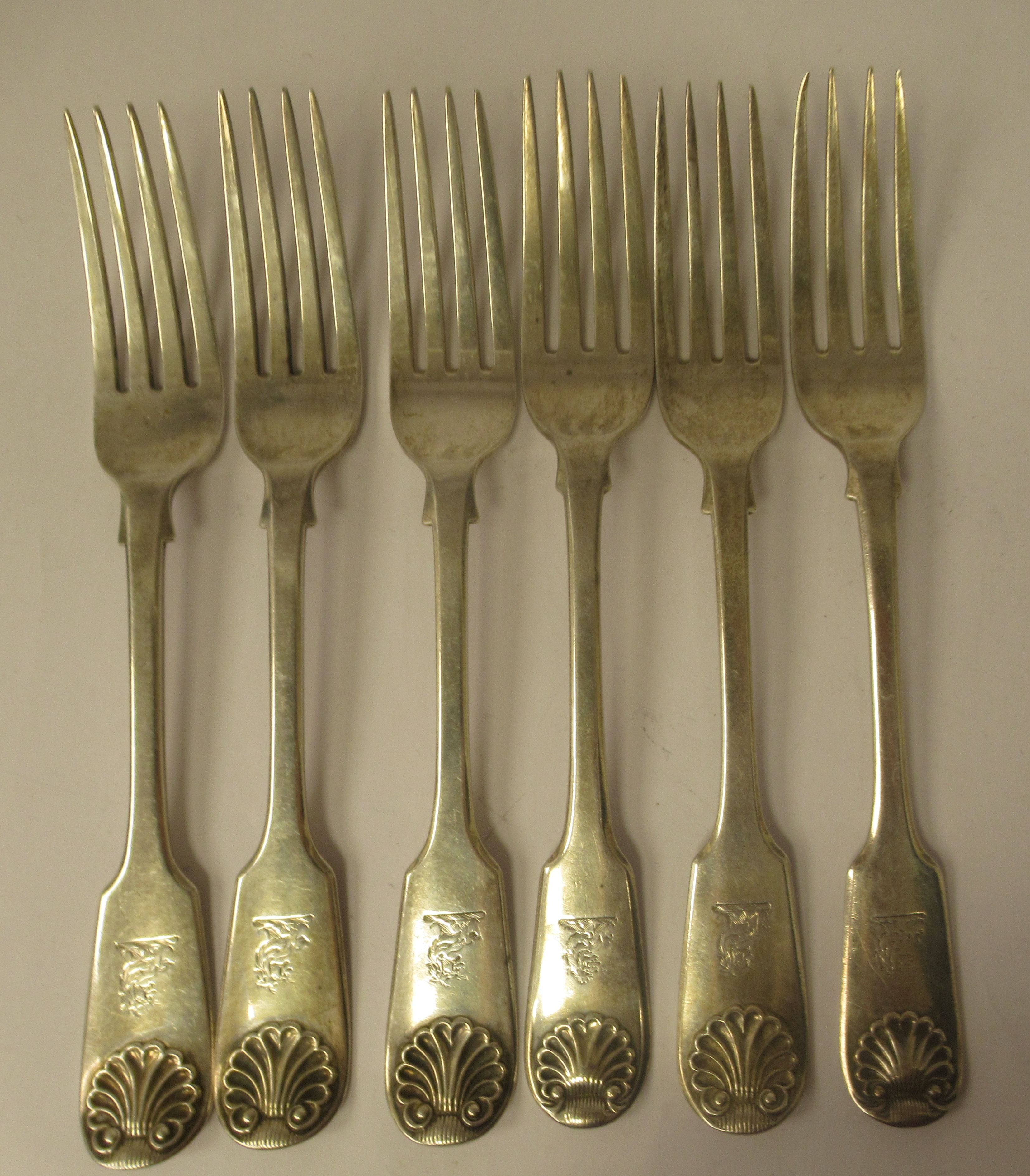 A matched set of six 19thC silver fiddle and shell pattern table forks  mixed marks