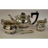 A three piece silver tea set of oval bulbous form, comprising a teapot with an S-shape spout,