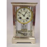 An early 20thC nickel plated, four glass mantel clock, on a bracket plinth; the French made gong