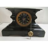 A 1930s slate cased breakfront mantel clock; the movement faced by a Roman dial  8"h
