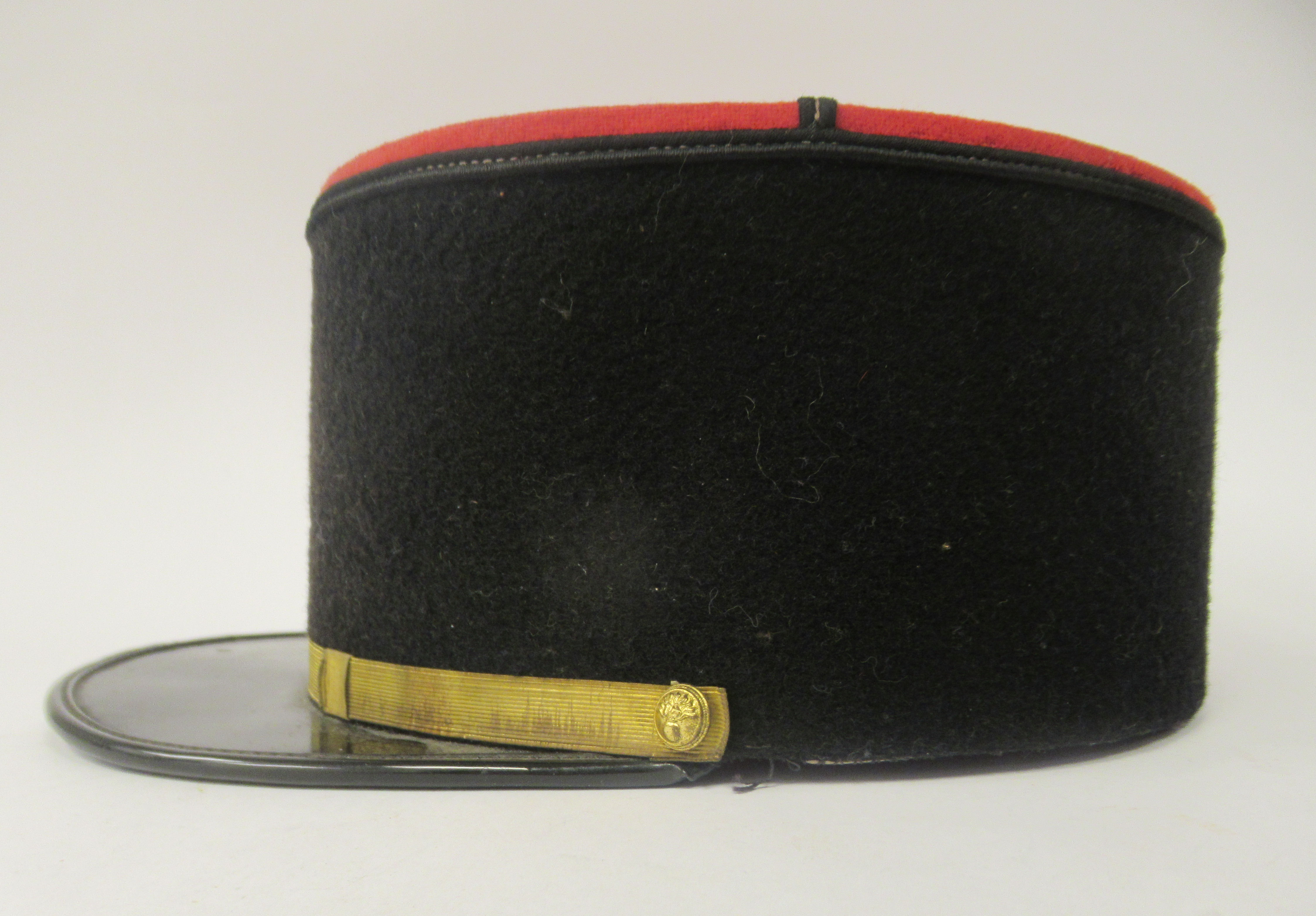 A vintage French Gendarme's black and red, peaked kepi