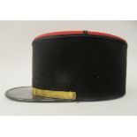 A vintage French Gendarme's black and red, peaked kepi